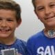 Two boys display their Brick Builders project.