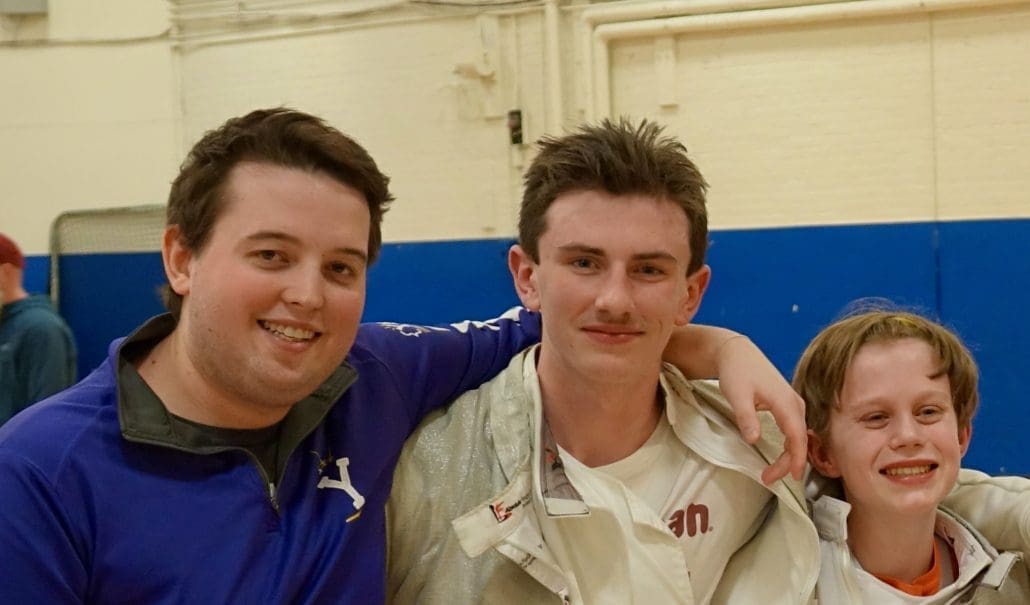 DSC04674 copy 2 Coach Murphy has his arm around one of his fencers.
